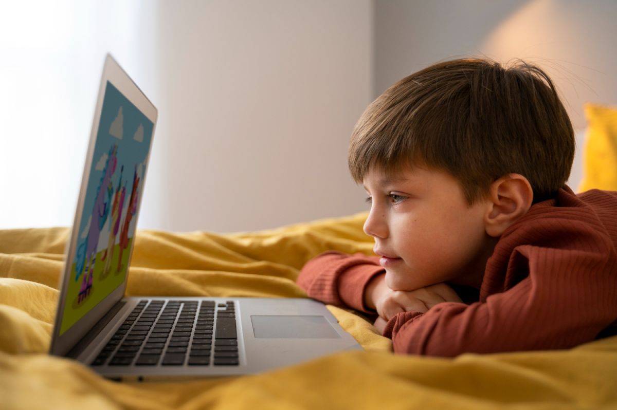 A toddler using a mobile device during playtime, representing screen exposure in early childhood.