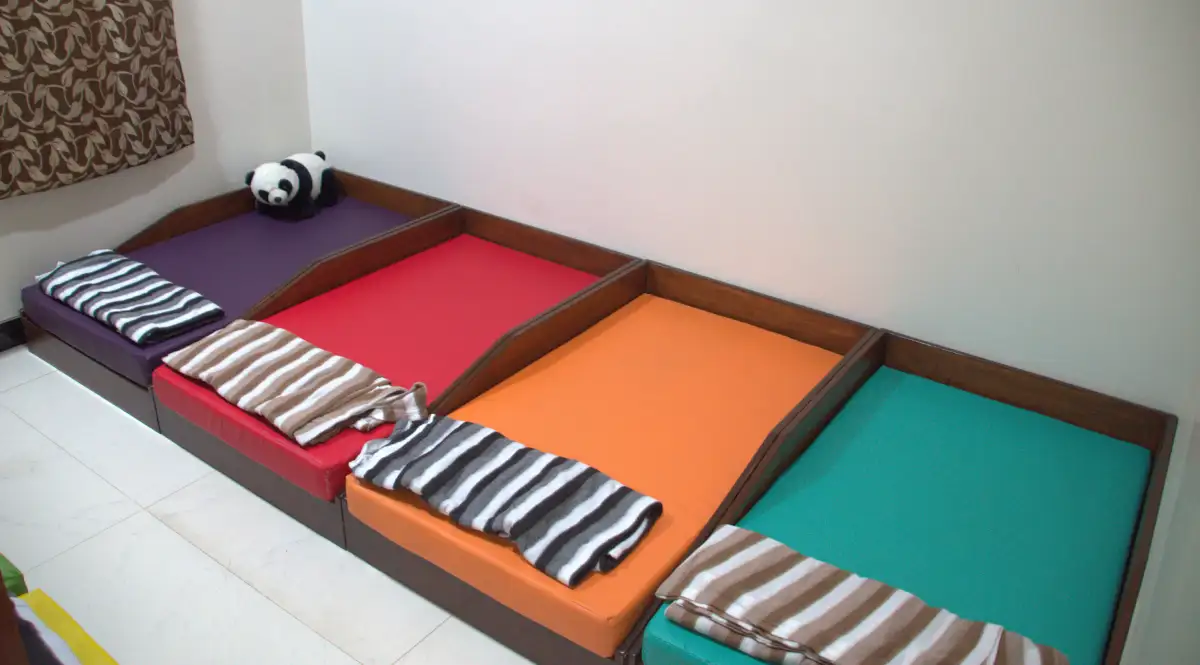 Toddler peacefully sleeping in a cosy daycare nap area, Elzee daycare facility.