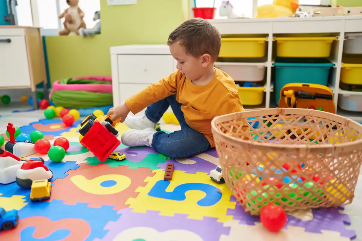 Toddler playing with a toy tractor in a preschool classroom, representing early learning and NEP 2020 preschool admission age guidelines in India