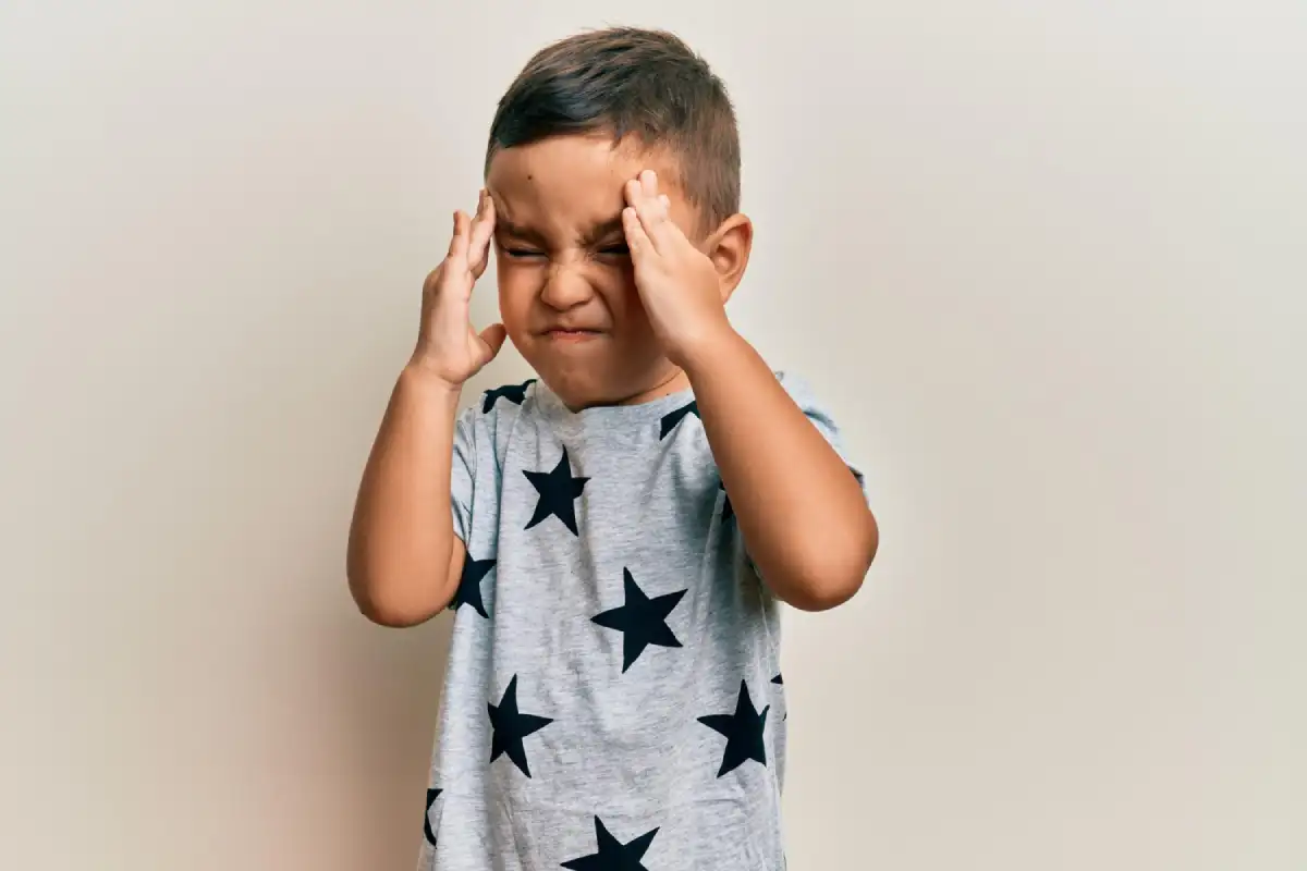 Toddler learning to recognise emotions using happy and sad expression cards in a preschool environment that supports emotional development and behaviour management