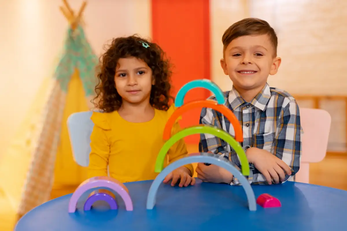 Young children playing with educational toys in a daycare classroom while learning routines, social skills, and early structured learning in a nurturing environment.